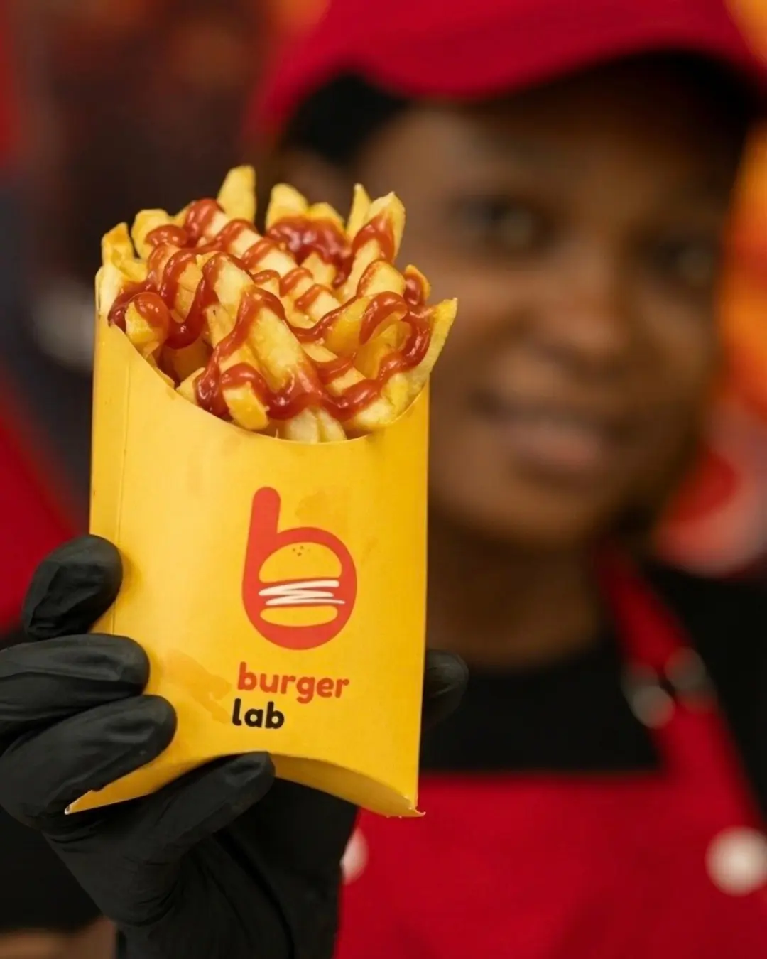 Burger Lab loaded fries presented by a team member